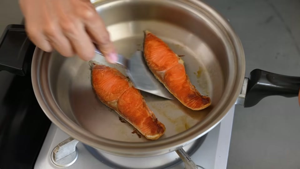 くっついた食材を金属ヘラで削ぎ剥がす